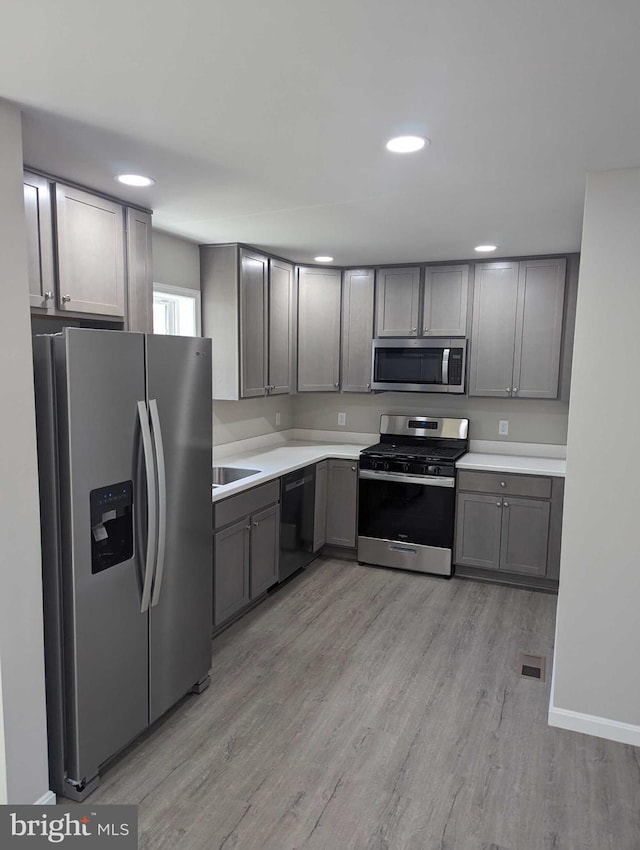 105 Fairfax Ln Unit 84, Dover, DE 19901 - kitchen featuring appliances with stainless steel finishes, gray cabinetry, light wood-style floors, light countertops, and recessed lighting