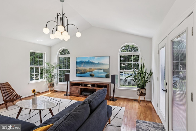 2640 E Colonial Dr, Upper Chichester, PA 19061 - living area featuring vaulted ceiling, wood finished floors, and a chandelier