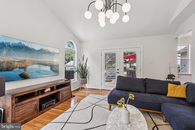 2640 E Colonial Dr, Upper Chichester, PA 19061 - living room featuring wood finished floors, a chandelier, vaulted ceiling, and french doors