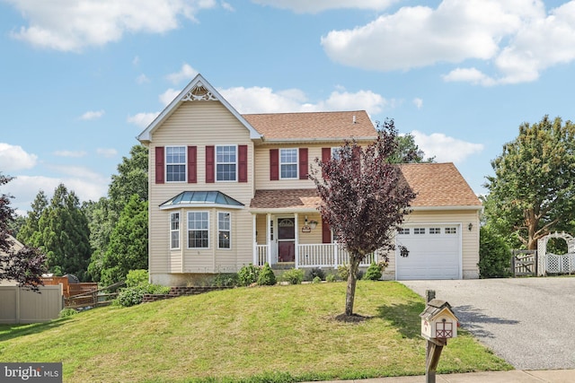 2640 E Colonial Dr, Upper Chichester, PA 19061 - view of front of home featuring driveway, a porch, a garage, and roof with shingles