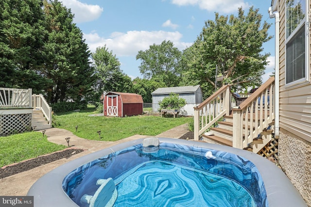 2640 E Colonial Dr, Upper Chichester, PA 19061 - view of swimming pool featuring stairway, a storage unit, a wooden deck, a hot tub, and a lawn