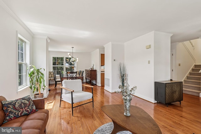 2640 E Colonial Dr, Upper Chichester, PA 19061 - living room featuring light wood-style flooring, stairway, and ornamental molding