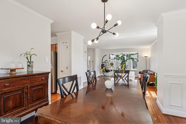 2640 E Colonial Dr, Upper Chichester, PA 19061 - dining space with crown molding, a chandelier, and light wood-style flooring