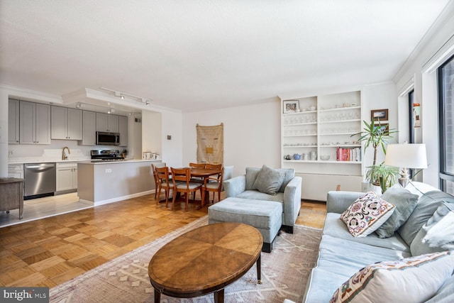 1280 21st St NW Unit 410, Washington, DC 20036 - living room with crown molding, track lighting, and built in features