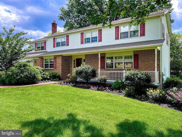 886 Laurel Ln, Harleysville, PA 19438 - view of front of home featuring covered porch, a chimney, a front lawn, and brick siding