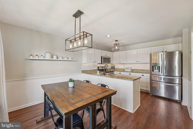 814 Amber Ln, West Chester, PA 19382 - kitchen with stainless steel appliances, white cabinets, decorative backsplash, dark wood-style flooring, and recessed lighting