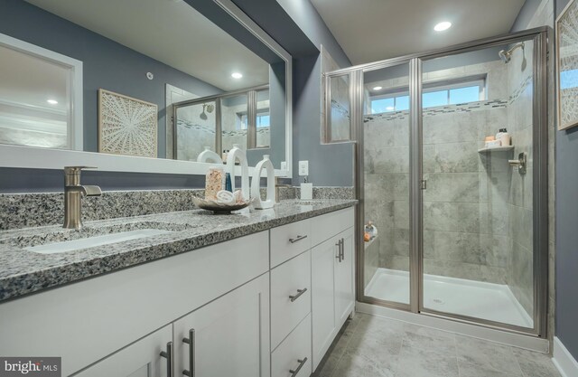7565 Dundee Rd, Baltimore, MD 21244 - bathroom featuring double vanity, a stall shower, and recessed lighting