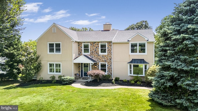558 Skippack Pike, Blue Bell, PA 19422 - traditional home featuring stone siding, a front yard, a chimney, and stucco siding
