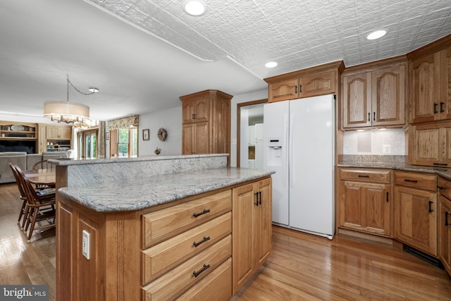 558 Skippack Pike, Blue Bell, PA 19422 - kitchen with white refrigerator with ice dispenser, an ornate ceiling, light stone countertops, a kitchen island, and recessed lighting