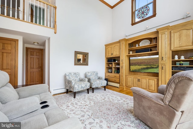 558 Skippack Pike, Blue Bell, PA 19422 - living area with baseboard heating, a high ceiling, wood finished floors, and crown molding