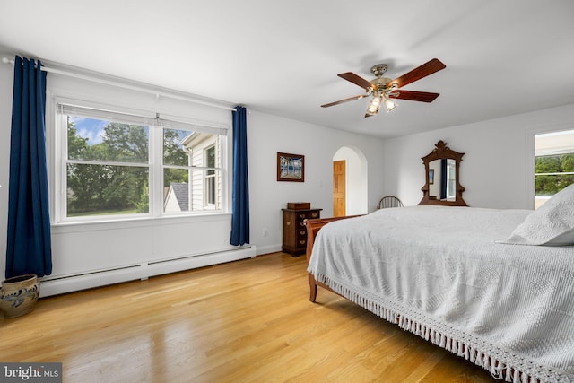558 Skippack Pike, Blue Bell, PA 19422 - bedroom with a baseboard heating unit, light wood finished floors, arched walkways, and ceiling fan