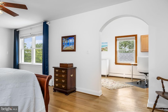 558 Skippack Pike, Blue Bell, PA 19422 - bedroom with arched walkways, a baseboard radiator, and light wood finished floors
