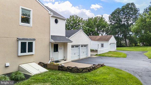 558 Skippack Pike, Blue Bell, PA 19422 - view of front of property featuring a shingled roof, a front lawn, a garage, and stucco siding