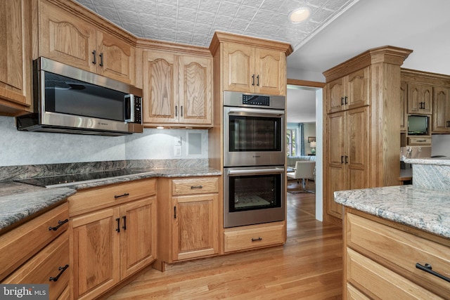 558 Skippack Pike, Blue Bell, PA 19422 - kitchen with stainless steel appliances, an ornate ceiling, light wood finished floors, and light stone counters