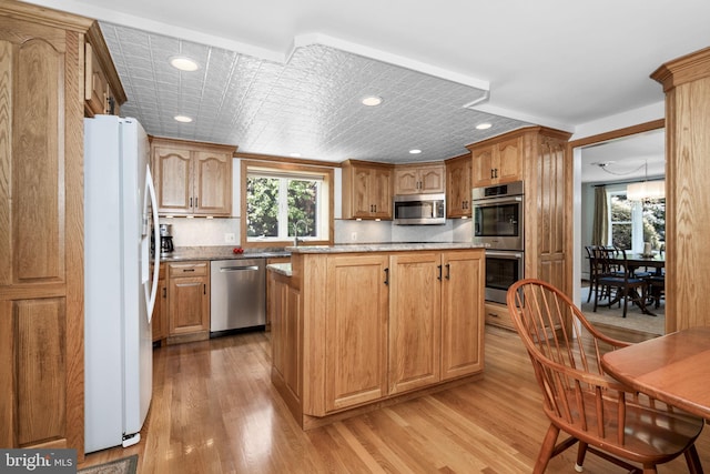 558 Skippack Pike, Blue Bell, PA 19422 - kitchen with appliances with stainless steel finishes, light wood-style flooring, plenty of natural light, a kitchen island, and recessed lighting
