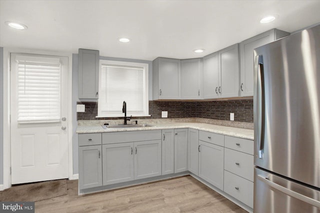 829-831 W Pine St, Coal Township, PA 17866 - kitchen featuring freestanding refrigerator, gray cabinetry, light wood-type flooring, backsplash, and recessed lighting