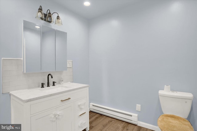 829-831 W Pine St, Coal Township, PA 17866 - bathroom featuring baseboard heating, backsplash, wood finished floors, vanity, and recessed lighting