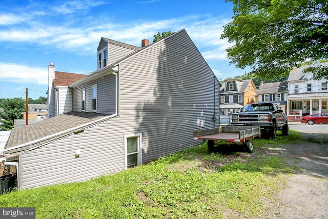 829-831 W Pine St, Coal Township, PA 17866 - view of side of home featuring a chimney and roof with shingles
