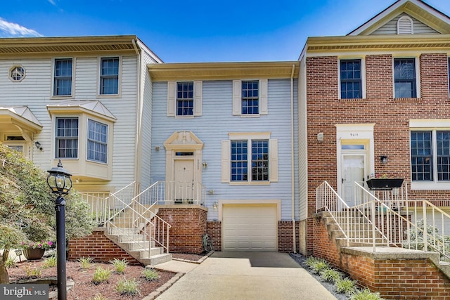 9009 Marie Ct, Lorton, VA 22079 - view of property with an attached garage, concrete driveway, and brick siding