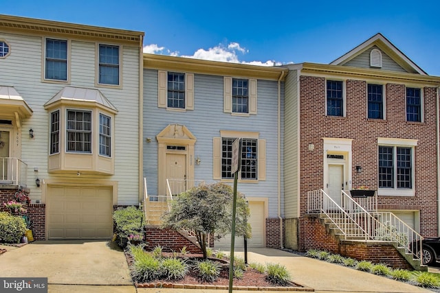 9009 Marie Ct, Lorton, VA 22079 - townhome / multi-family property with a garage, driveway, and stairs