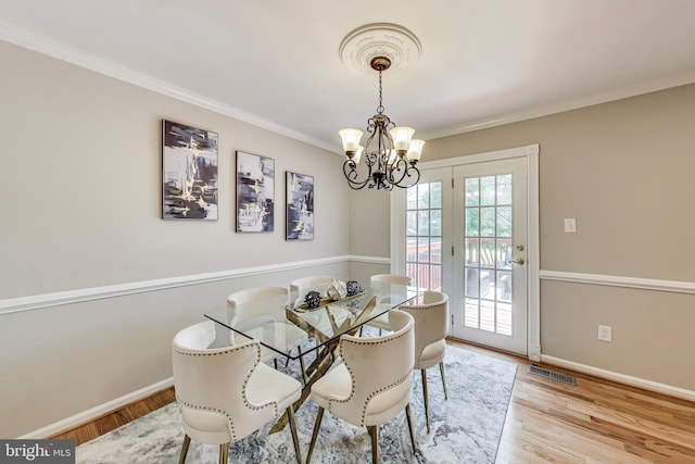 9009 Marie Ct, Lorton, VA 22079 - dining space with a chandelier, ornamental molding, and wood finished floors