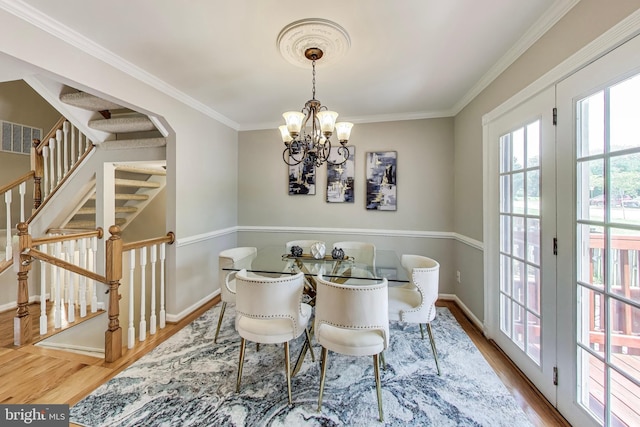 9009 Marie Ct, Lorton, VA 22079 - dining area featuring wood finished floors, ornamental molding, a chandelier, and stairway