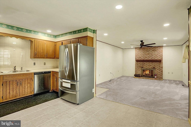 528 Fairway Dr, Camp Hill, PA 17011 - kitchen with stainless steel appliances, ceiling fan, light countertops, brown cabinets, and a brick fireplace