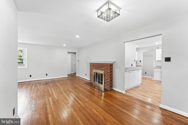 3834 Nancy Ave, Wilmington, DE 19808 - unfurnished living room with light wood-type flooring and a fireplace