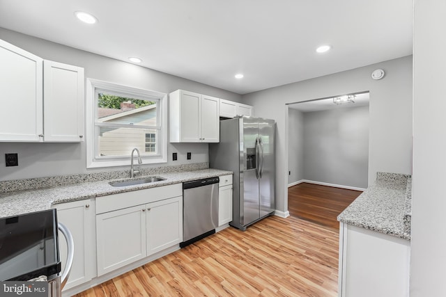 3834 Nancy Ave, Wilmington, DE 19808 - kitchen with stainless steel appliances, white cabinetry, light wood-style floors, light stone countertops, and recessed lighting