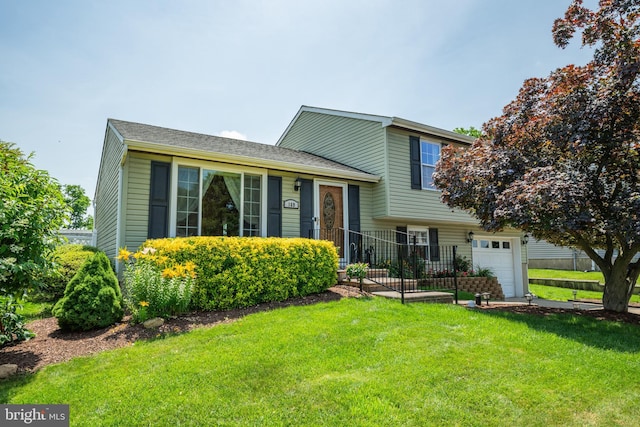169 Independence Dr, Morrisville, PA 19067 - tri-level home with a front yard, a garage, and concrete driveway