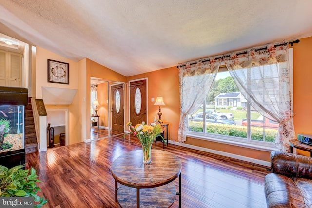 169 Independence Dr, Morrisville, PA 19067 - living area featuring lofted ceiling, wood finished floors, and a textured ceiling