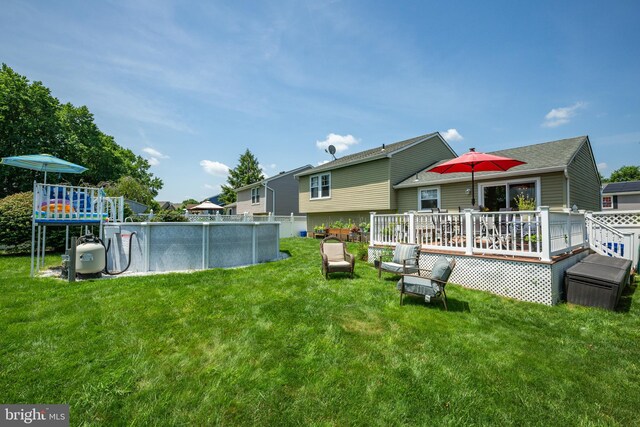 169 Independence Dr, Morrisville, PA 19067 - view of green lawn featuring a deck and an outdoor pool