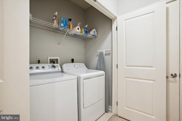 2655 Prosperity Ave Unit 100, Fairfax, VA 22031 - laundry room with washing machine and clothes dryer and light tile patterned flooring
