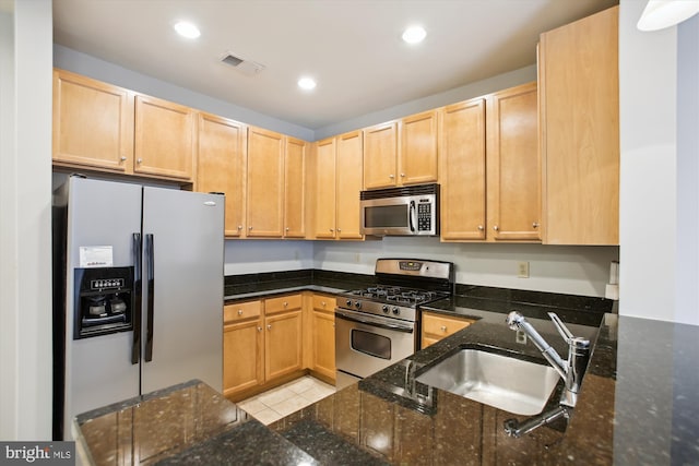 2655 Prosperity Ave Unit 100, Fairfax, VA 22031 - kitchen with stainless steel appliances, light brown cabinets, recessed lighting, dark stone counters, and light tile patterned floors