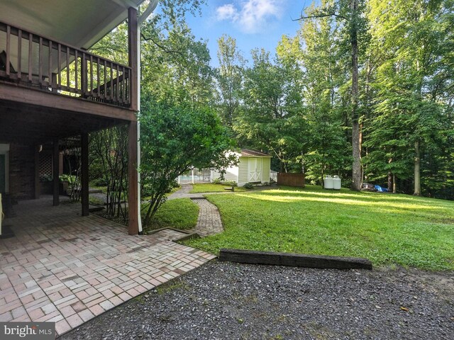 7491 Slagle Ln, Manassas, VA 20111 - view of grassy yard with a patio, an outbuilding, and a wooden deck