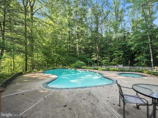 7491 Slagle Ln, Manassas, VA 20111 - view of pool featuring an in-ground hot tub, a patio, and a view of trees