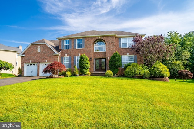 14 Stanley Dr, Monroe Township, NJ 08831 - colonial inspired home with french doors, a front yard, brick siding, and asphalt driveway
