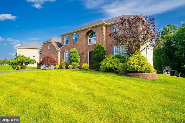 14 Stanley Dr, Monroe Township, NJ 08831 - view of front facade with a front yard and brick siding