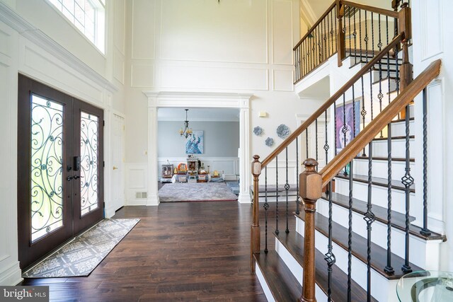 14 Stanley Dr, Monroe Township, NJ 08831 - entrance foyer with a decorative wall, french doors, a towering ceiling, wood finished floors, and a chandelier