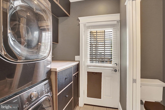 127 Spruce St, Middletown, PA 17057 - washroom with stacked washing machine and dryer and light tile patterned flooring