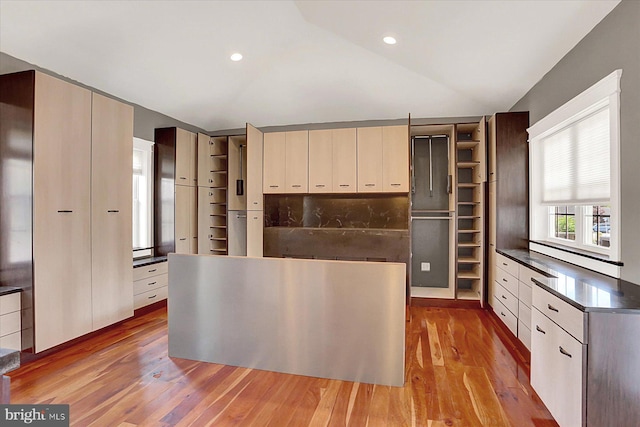 127 Spruce St, Middletown, PA 17057 - kitchen featuring open shelves, lofted ceiling, light wood finished floors, and dark countertops