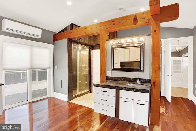 127 Spruce St, Middletown, PA 17057 - full bath with a wall unit AC, lofted ceiling, wood finished floors, vanity, and a shower stall