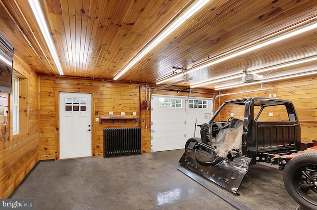 127 Spruce St, Middletown, PA 17057 - garage featuring radiator, wooden walls, and a garage door opener