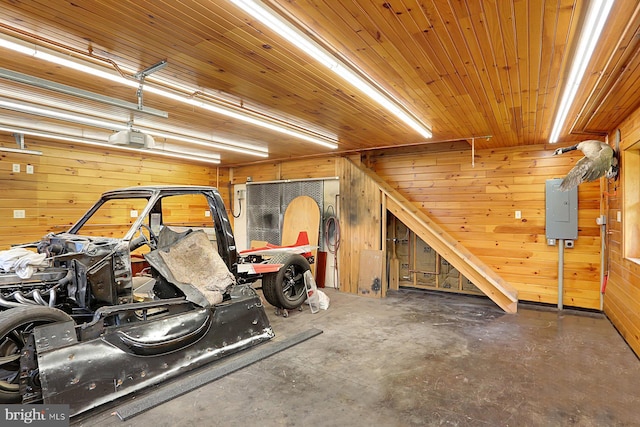 127 Spruce St, Middletown, PA 17057 - garage featuring electric panel, wood walls, a garage door opener, and wooden ceiling