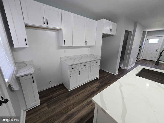 940 E 41st St, Baltimore, MD 21218 - kitchen featuring dark wood finished floors, light stone counters, and white cabinetry
