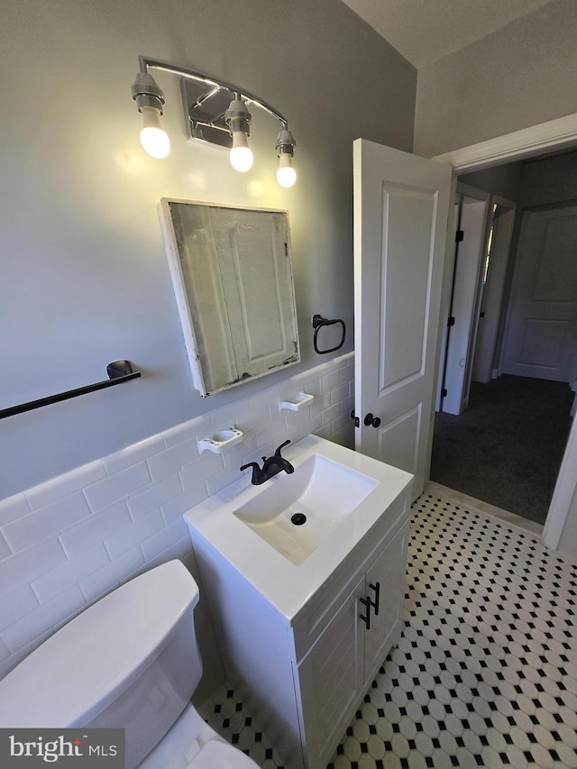 940 E 41st St, Baltimore, MD 21218 - bathroom with vanity, tile walls, and a wainscoted wall