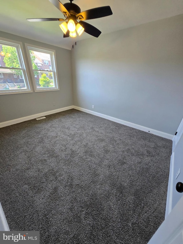 940 E 41st St, Baltimore, MD 21218 - spare room with dark carpet and ceiling fan