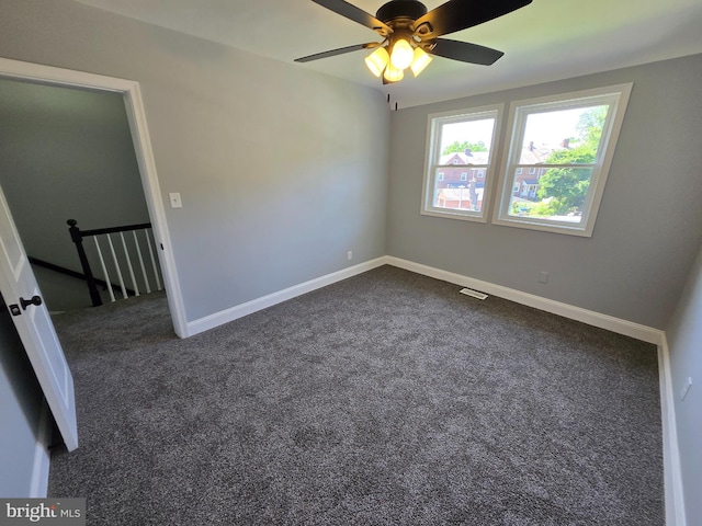 940 E 41st St, Baltimore, MD 21218 - unfurnished room with dark colored carpet and a ceiling fan