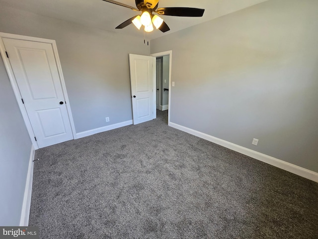 940 E 41st St, Baltimore, MD 21218 - unfurnished bedroom with dark carpet and a ceiling fan