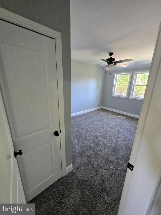 940 E 41st St, Baltimore, MD 21218 - unfurnished room featuring dark carpet and ceiling fan